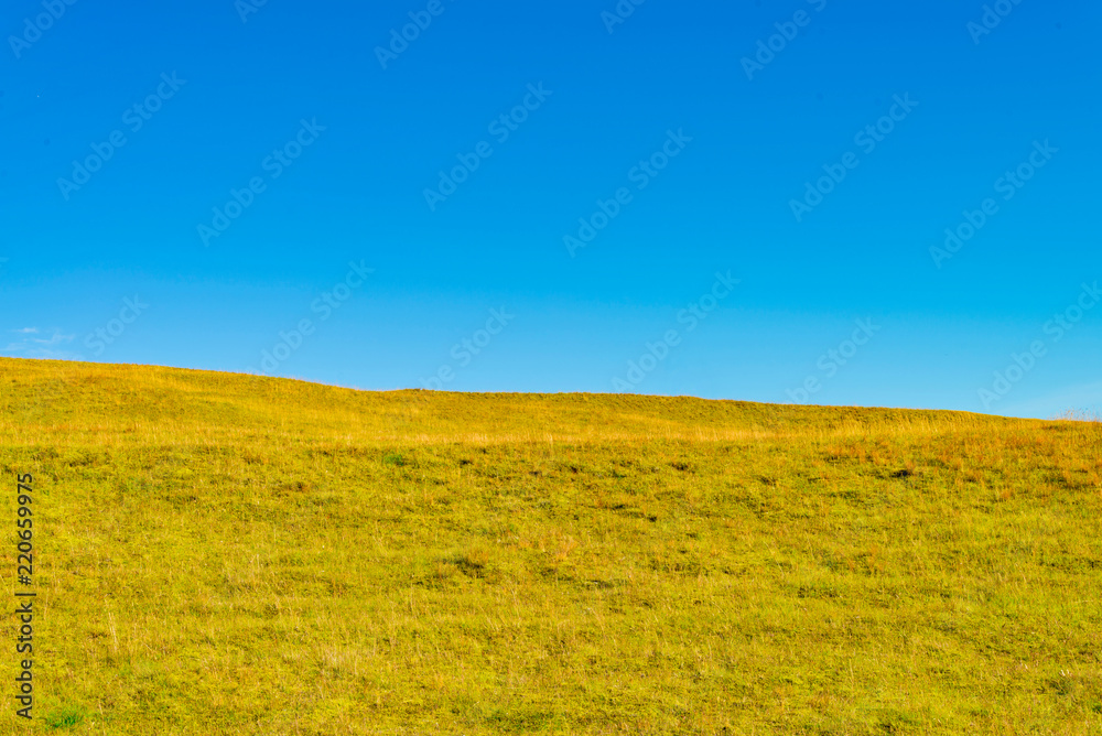 Grass hill and blue sky