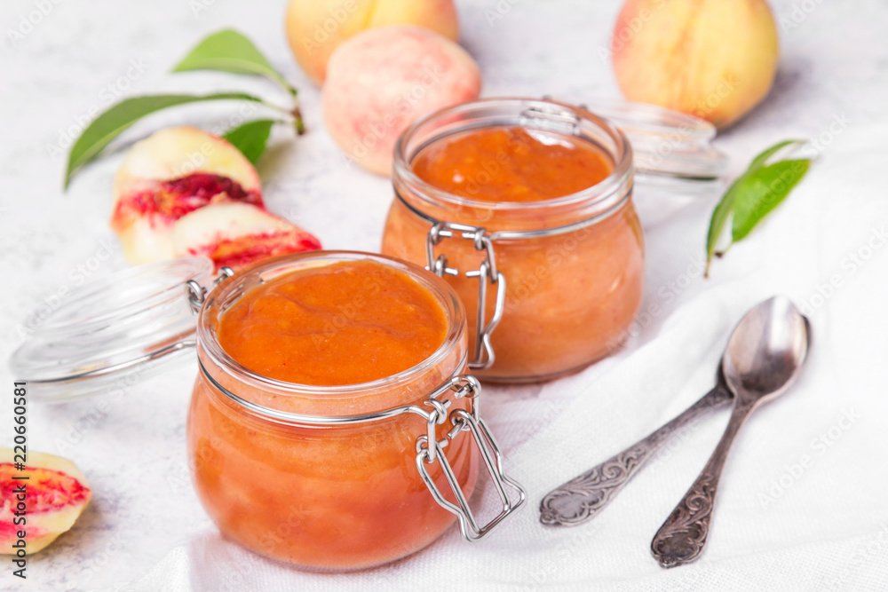 Homemade peach jam with organic fruit. Sweet preserves on a light background Homemade peach jam with organic fruit. Sweet preserves on a light background