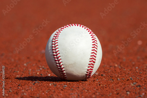 new baseball ball on red track rubber