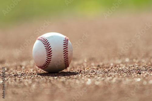new baseball ball on red track rubber photo