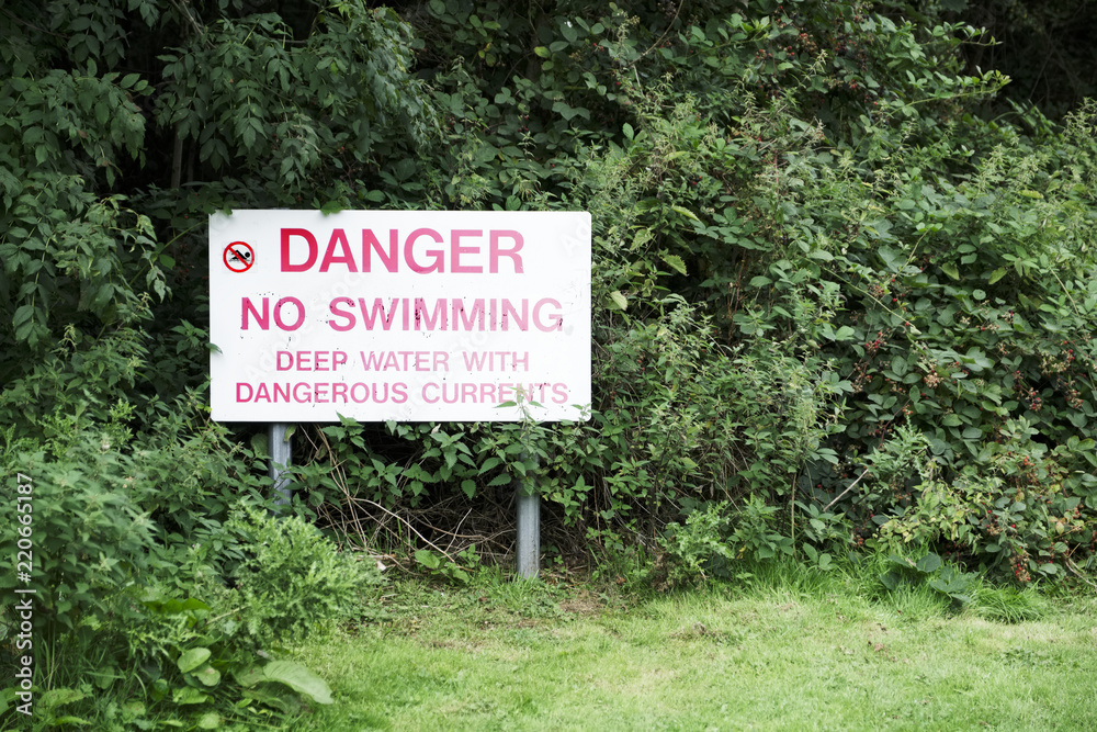 No swimming danger sign near deep water and dangerous currents