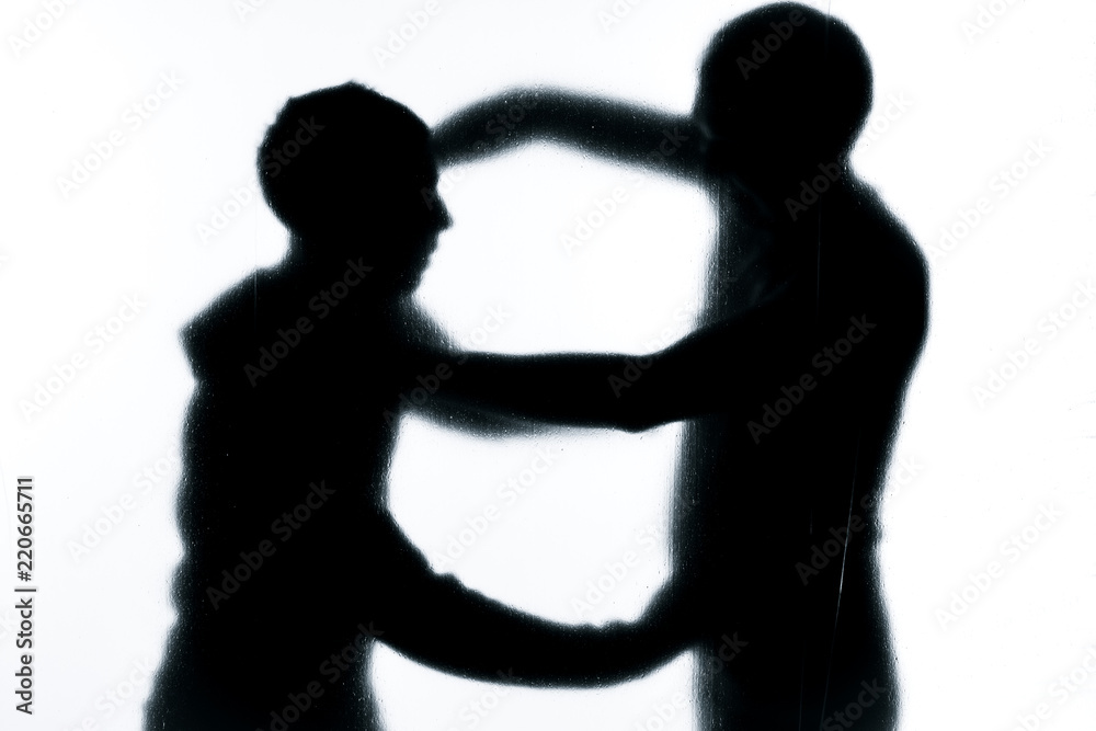 Self-defense battle silhouette. A man fights against an aggressor with a knife. Fight for life against terrorists