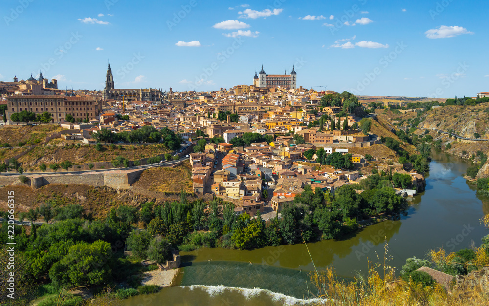 Skyline of Toledo, beautiful city of Spain. Sunny landscape with view of the main monuments and Tagus river. Panoramic of Toledo, Castilla-La Mancha.