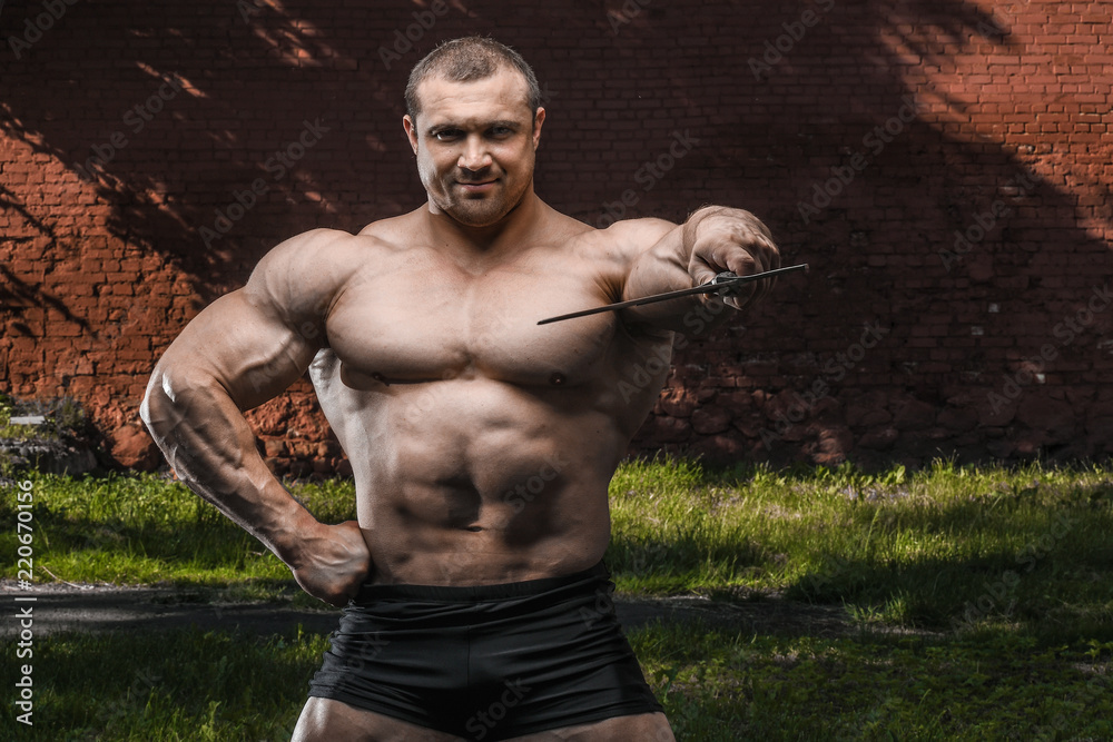 Fototapeta premium outdoor sport Brutal strong muscular men with sword