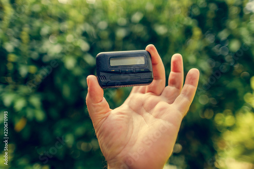 pagers. old vintage beeper. pager in hand photo
