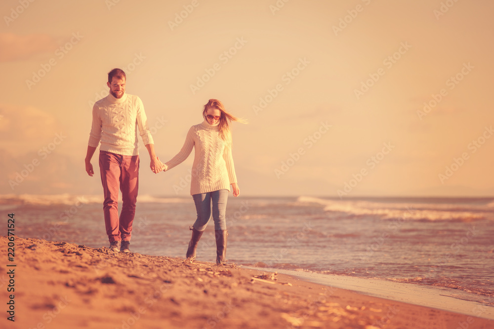 Fototapeta premium Loving young couple on a beach at autumn sunny day