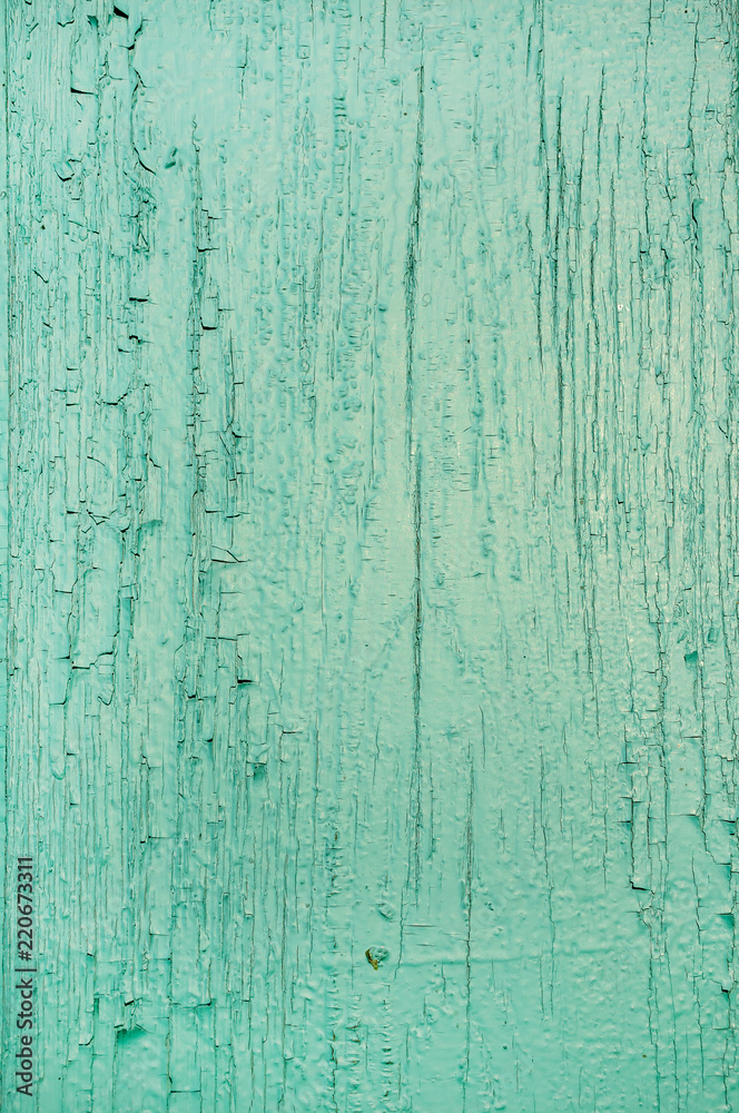 Texture of old scratched wooden planks with cracked and peeling green paint Texture of old scratched wooden planks with cracked and peeling green paint