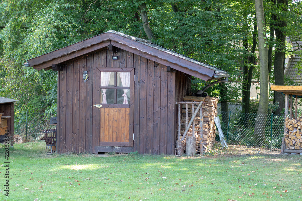Small wooden summerhouse in the garden Small wooden summerhouse in the garden