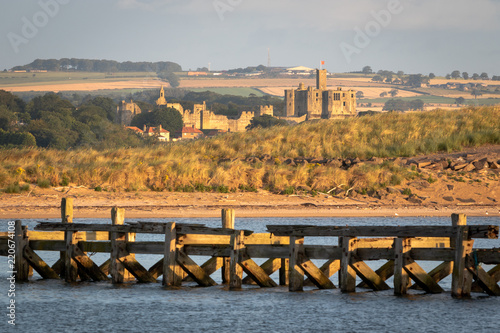 View of Warkworth castle from a distance in the early morning. Northumberland, United Kingdom photo