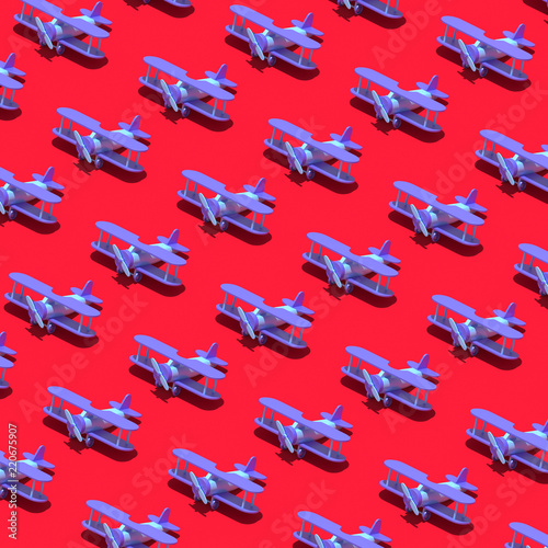 Colorful blue airplane pattern on pastel red background. Creative minimal kid flat lay.