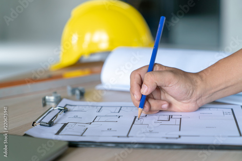 Architect & Engineer working drawing document about project planning and progress of work schedule on the home building construction site , Drawing docement is make new for stock NOT COPYRIGHT