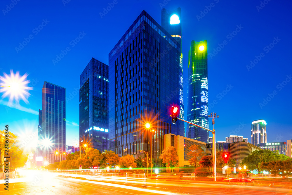 modern office buildings at night in downtown of NanChang on view from busy road