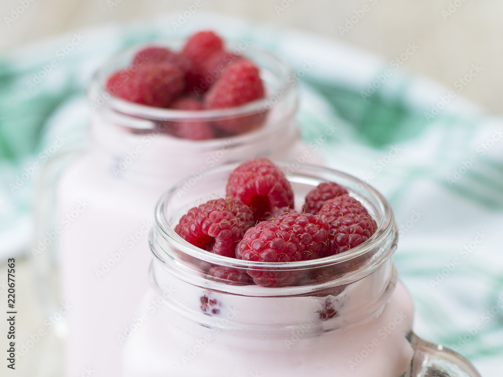 Raspberry yogurt on a wooden table. Raspberry yogurt on a wooden table.