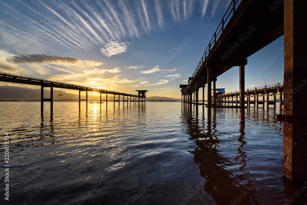 The bridge into the lake with sunrise sky