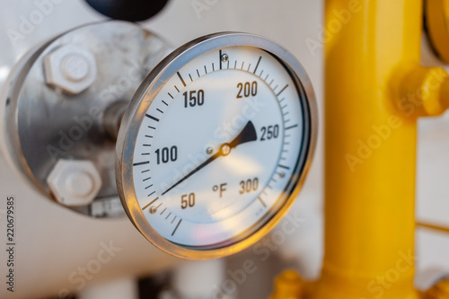 Thermometer, Temperature gauge or temperature indicator reading seventy five Fahrenheit (°F) in offshore oil and gas refinery process operation industry.