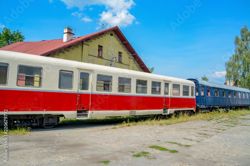 Old railway cars on an abandoned station against a blue sky