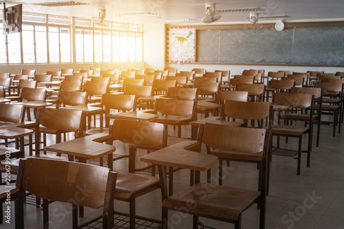 Empty classroom with vintage tone wooden chairs. Back to school concept. photo