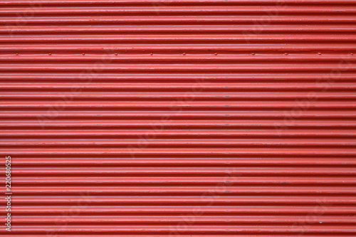 Corrugated red metal surface