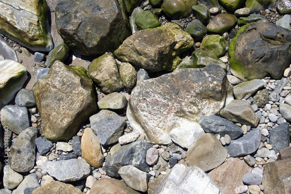 A view of rocks and stones at the Malibu beach from an high angle view for backgrounds or wallpapers in summer time