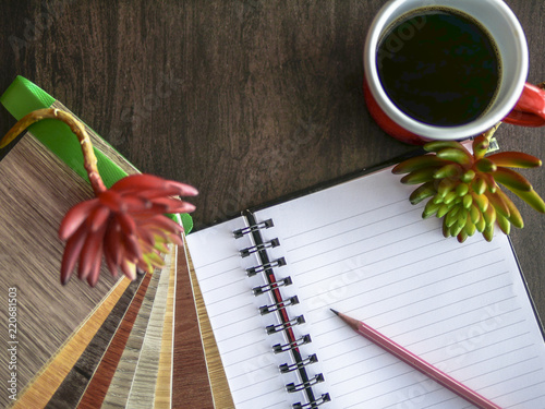 blank notepad and vinyl sample wood flooring with hot coffee cup on wooden vinyl floor space 