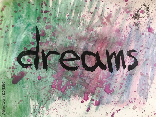 Follow your dreams motivational message over colorful painted background.