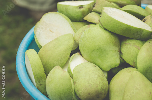 blue pailful of pears/pailful of the ripe cut pears, selective focus photo