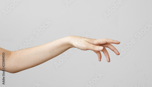 Female hand touching on gray background photo