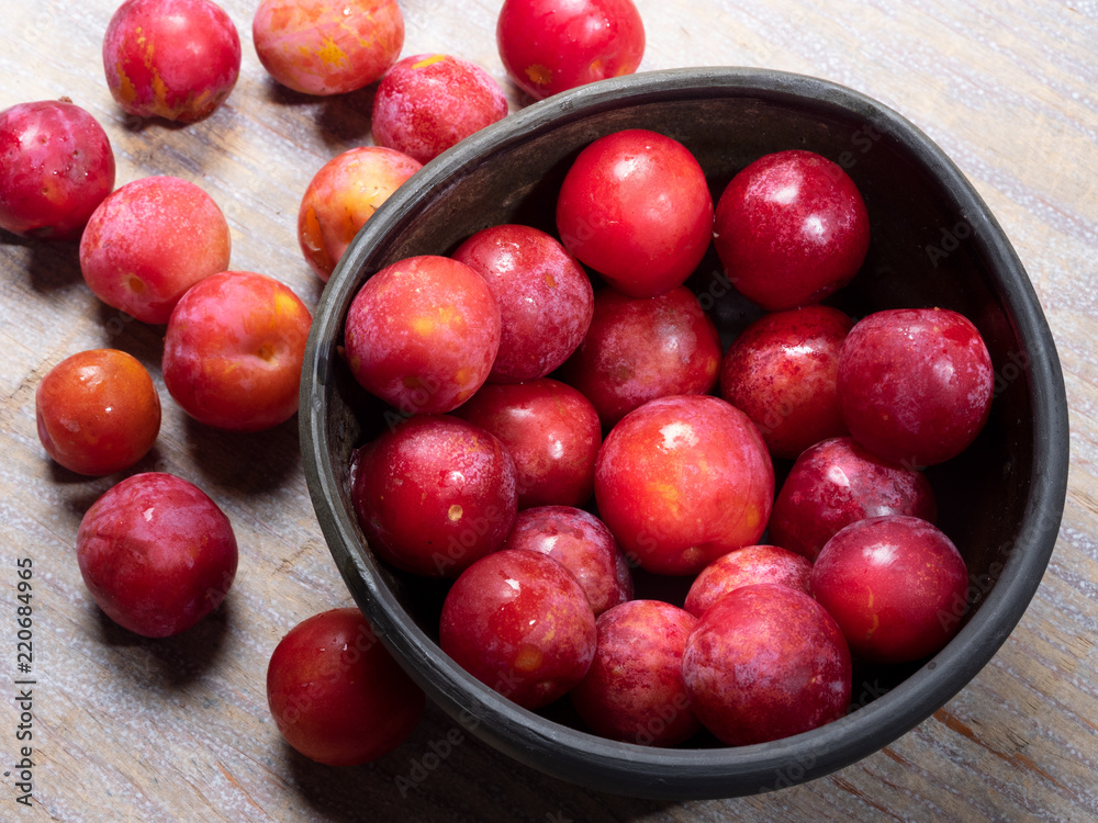 Rip ecologically grown plums in a bowl Rip ecologically grown plums in a bowl