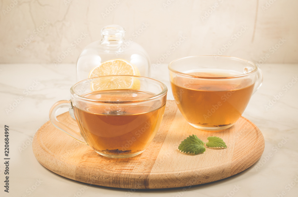 mint tea in glass with lemon/ mint tea in glass with lemon on a wooden tray. Selective focus mint tea in glass with lemon/ mint tea in glass with lemon on a wooden tray. Selective focus