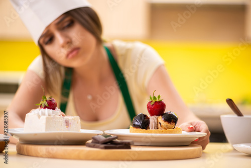 Young cook cooking cakes in the kitchen