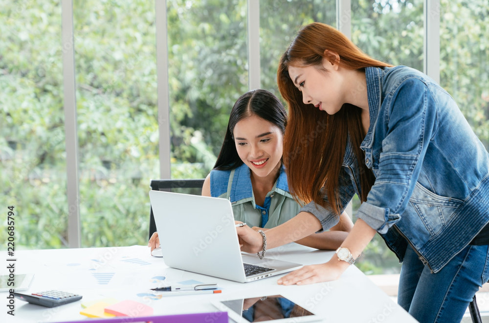 Business meeting. Two young coworker woman team making business discussion in modern office. Teamwork people concept. Casual account manager crew working new startup project on laptop. Presentation Business meeting. Two young coworker woman team making business discussion in modern office. Teamwork people concept. Casual account manager crew working new startup project on laptop. Presentation