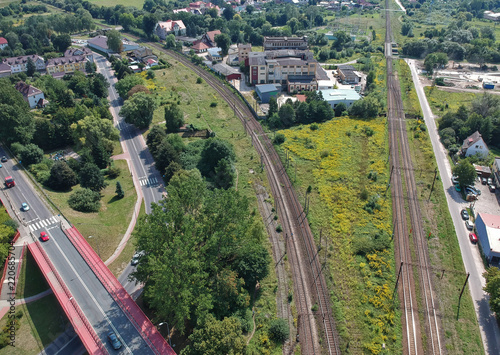 Aerial view on of railroad and car road in city.