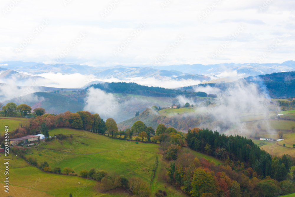 Green hills and mountains in the fog in Tineo, Asturias, Spain