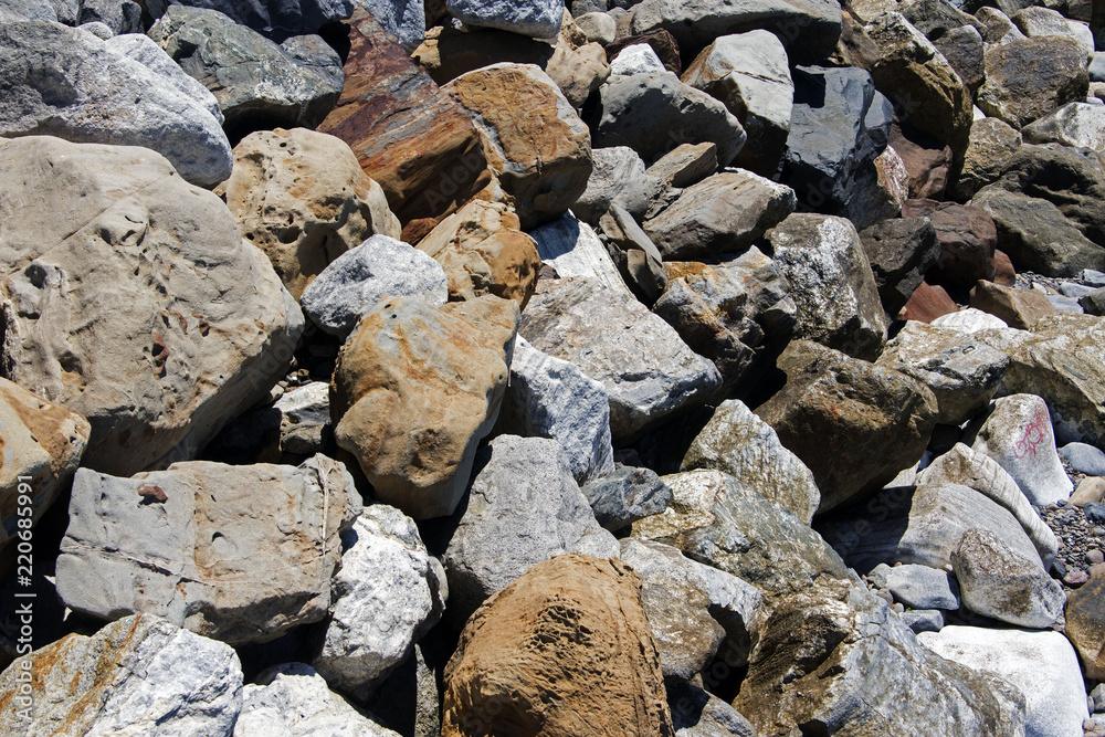 A view of rocks and stones at the Malibu beach from an high angle view for backgrounds or wallpapers in summer time