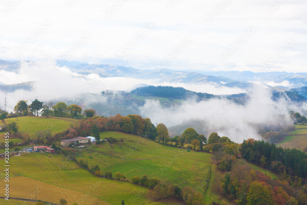 Green hills and mountains in the fog in Tineo, Asturias, Spain Green hills and mountains in the fog in Tineo, Asturias, Spain
