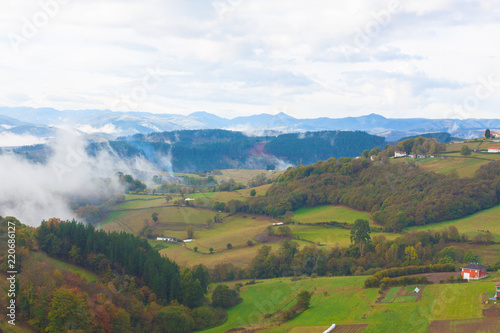 Green hills and mountains in the fog in Tineo, Asturias, Spain