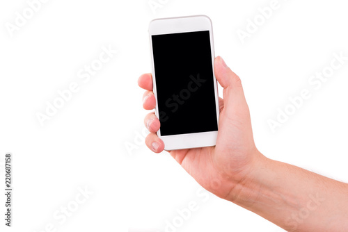 Mobile phone in hand. White smartphone held by the hand isolated on a white background. Hand holding a white phone with a blank display, white background.