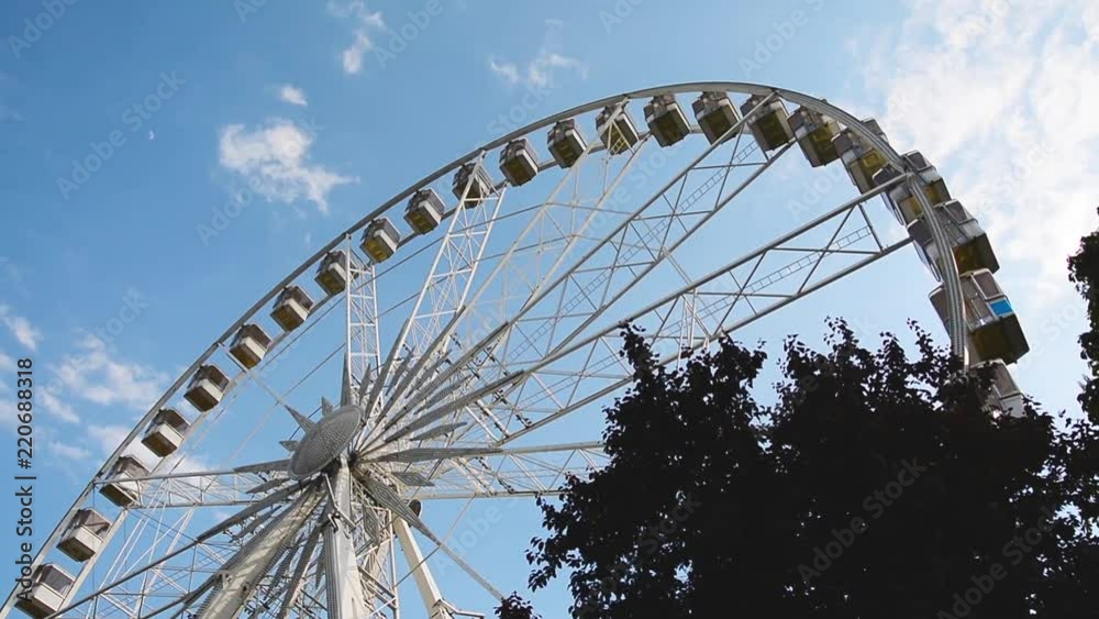 Ferris wheel on the background of blue sky in the city Ferris wheel on the background of blue sky in the city