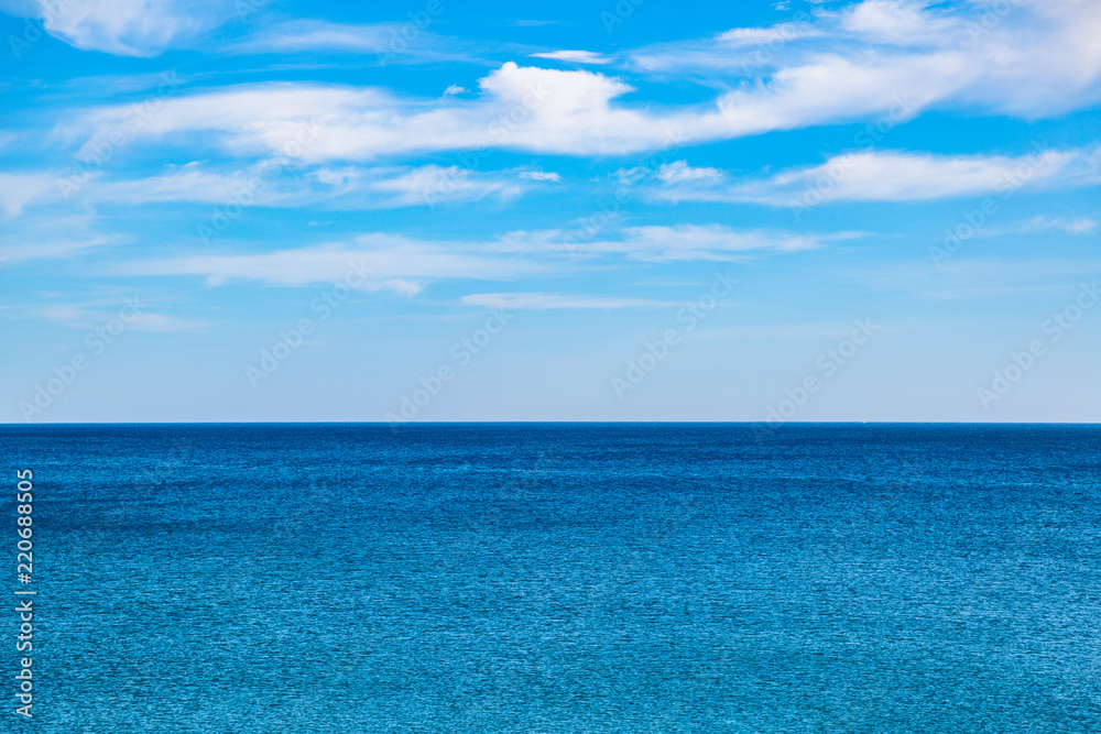 Panorama of merging blue sky and sea