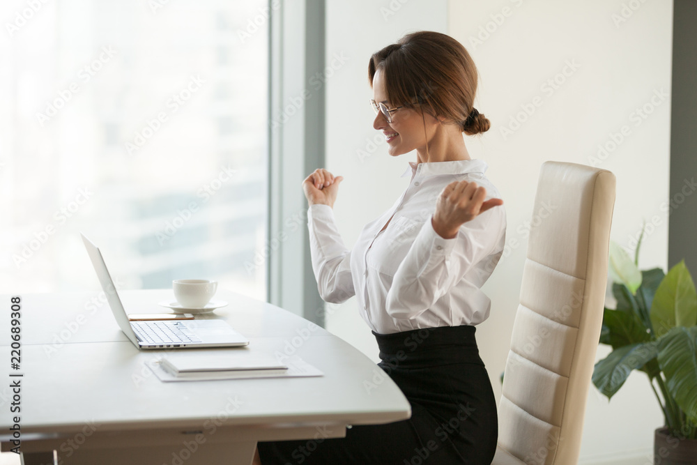 Happy businesswoman winner feels excited reading good news in email letter, glad office employee looking at laptop celebrating online win result achievement concept, got great offer, being promoted Happy businesswoman winner feels excited reading good news in email letter, glad office employee looking at laptop celebrating online win result achievement concept, got great offer, being promoted