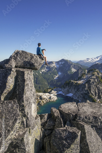 Fototapeta Naklejka Na Ścianę i Meble -  Traveler man watching sunset on the top of the mountain 