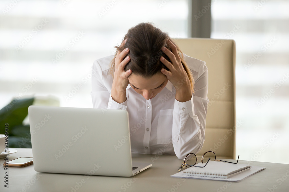 Frustrated stressed businesswoman holding head in hands shocked by bankruptcy or business failure feeling panic after reading bad news online, desperate entrepreneur lost money, got problem or debt Frustrated stressed businesswoman holding head in hands shocked by bankruptcy or business failure feeling panic after reading bad news online, desperate entrepreneur lost money, got problem or debt
