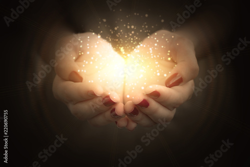 magic particles on the palms of a woman  a stream of magical energy emanating from female hands