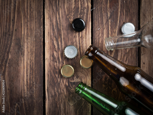 Empty beer bottles with bottle caps on table wood,after party,top view