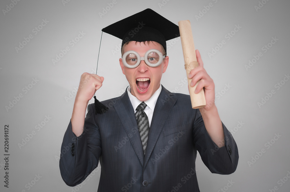 Delighted graduate student in the cap with diploma certificate isolated on gray background. Education concept. Delighted graduate student in the cap with diploma certificate isolated on gray background. Education concept.