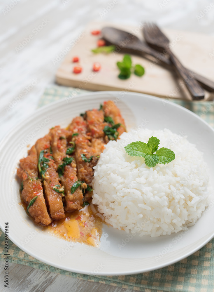 Thai spicy food,Stir-fried chicken whit basil with rice on table wood Thai spicy food,Stir-fried chicken whit basil with rice on table wood