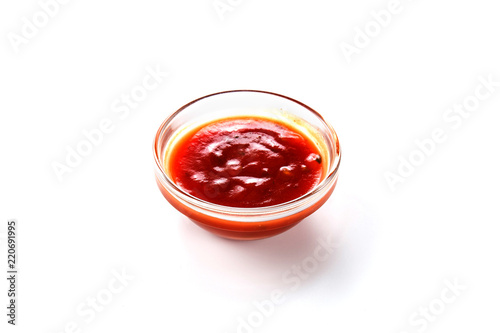 Sauce in a glass bowl on white background (close up)