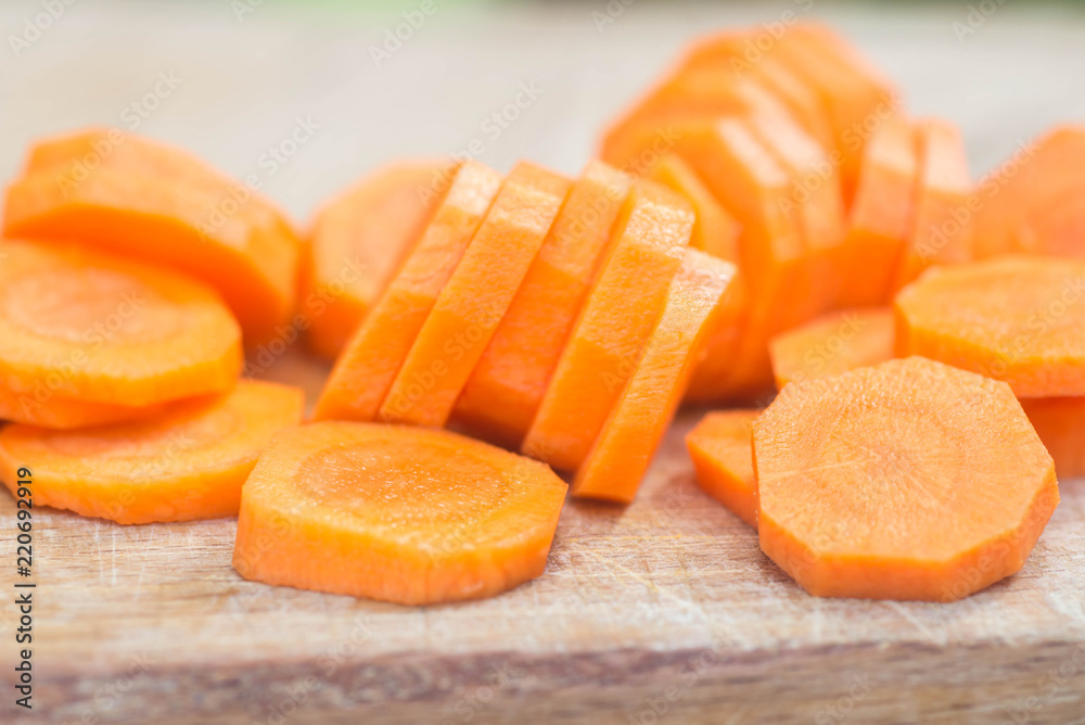 sliced carrot on wooden cutting board sliced carrot on wooden cutting board