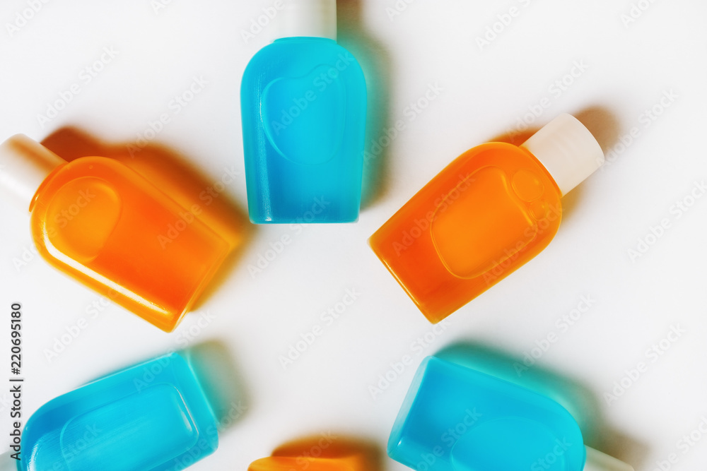 Blank cosmetics shampoo bottles on white paper background. Set of toiletries. Flat lay.