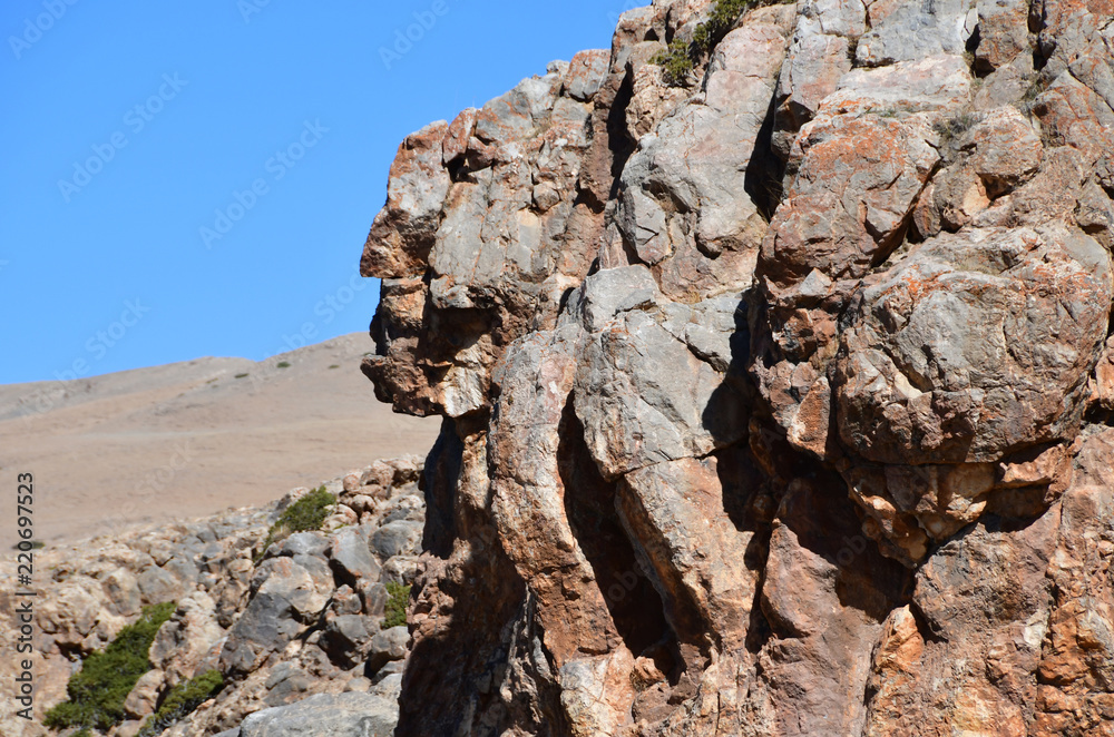 Tibet, one of the geoglyphs on rock on the shore of the sacred lake Nam-Tso (Nam Tso) against the blue sky, 4718 meters above sea level Tibet, one of the geoglyphs on rock on the shore of the sacred lake Nam-Tso (Nam Tso) against the blue sky, 4718 meters above sea level